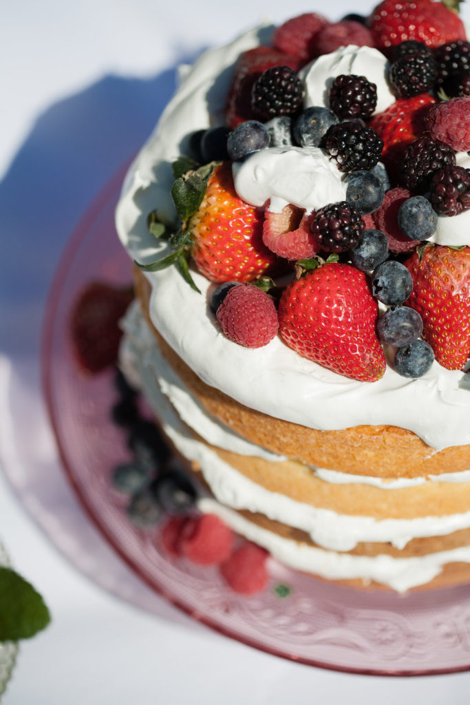 naked wedding cake with berries